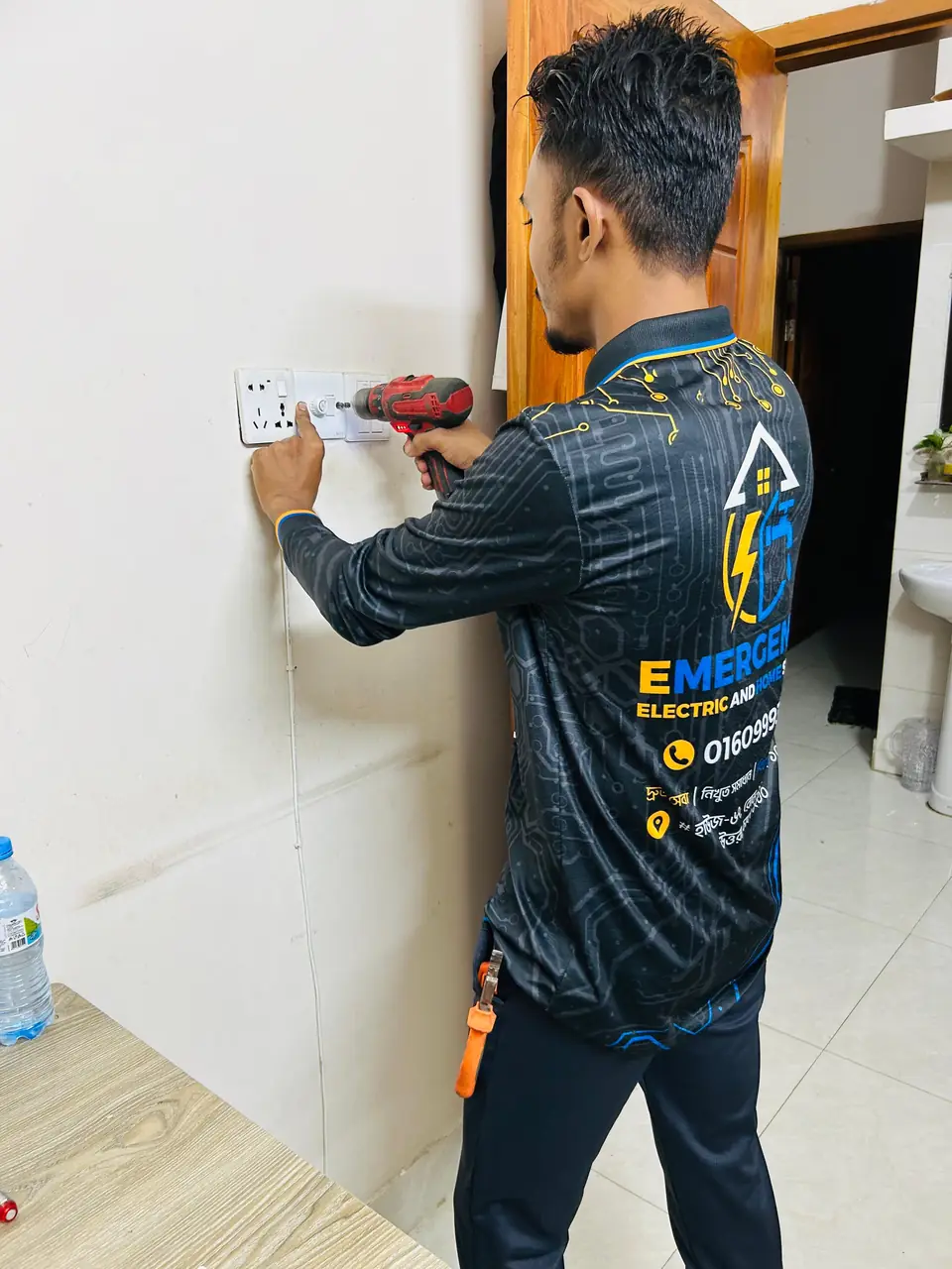 Technician drilling to fit a new power socket